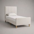 Lit simple rembourré en tissu écru 90 x 190 cm avec tête de lit à canaux, pied de lit et sommier à lattes